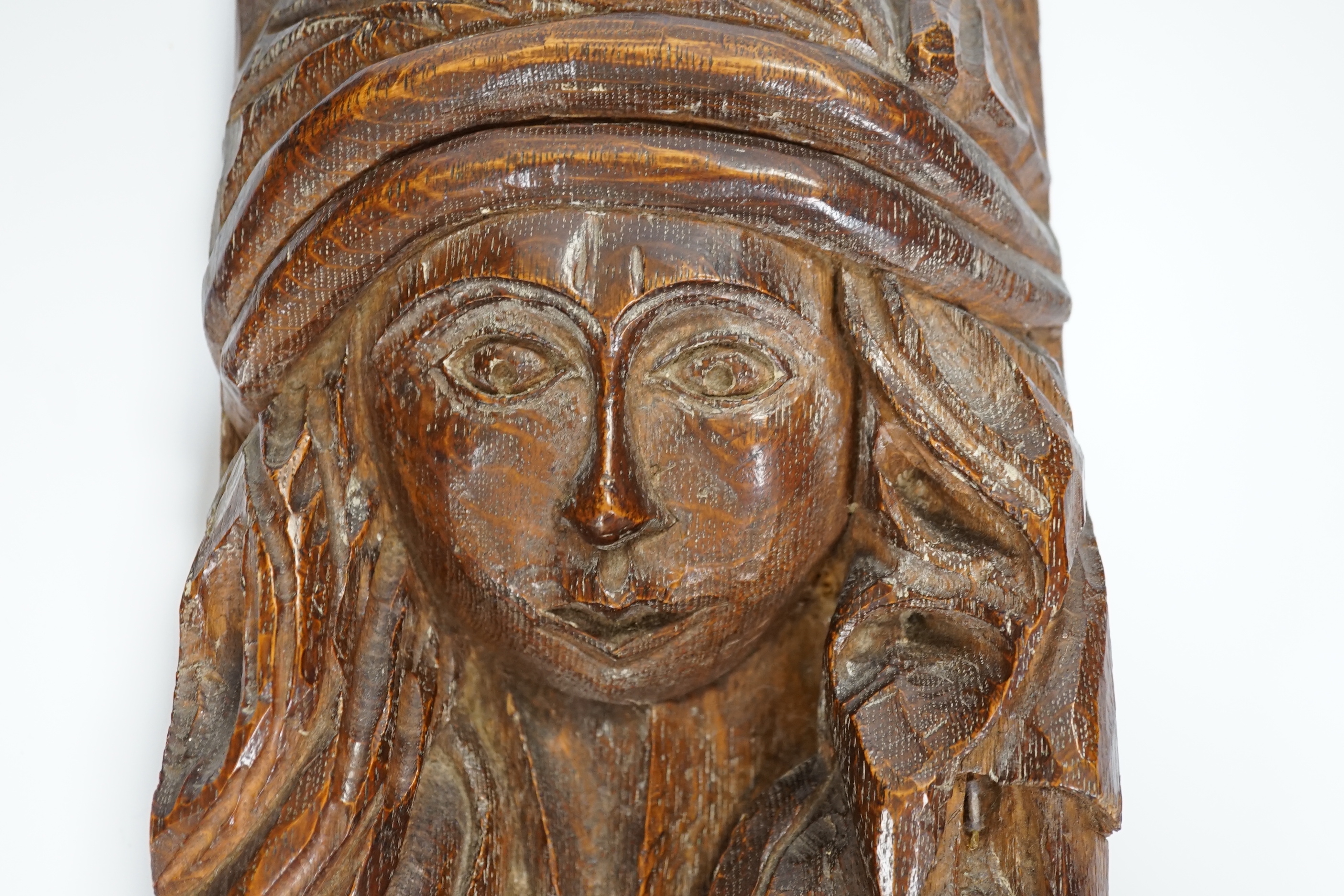 A small carved oak figure of a maiden, 28cms high